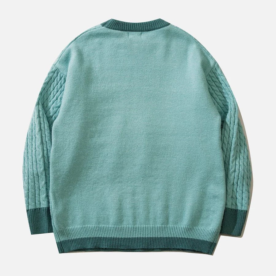 Sabrina - kabelstrikket sweater med pastelsky motiv